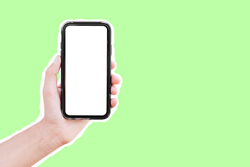 Male hand holding smartphone with mockup, isolated with white contour on green.