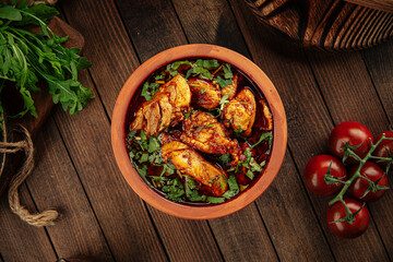 Georgian dish chakhokhbili stewed chicken in a clay bowl