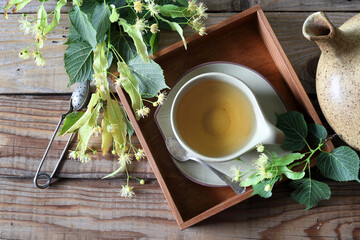 Lime leaf tea. Cup of herbal tea with linden flowers