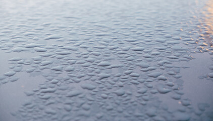 Abstract background ornament with water drops. Raindrops on a polished surface.