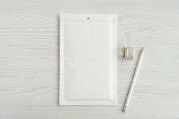 White paper bubble envelope, blank post package, mockup for design presentation, top view.