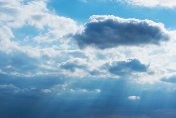 Fototapeta premium Dramatic blue sky with clouds and sun rays.Summer Sun rays at sunset.