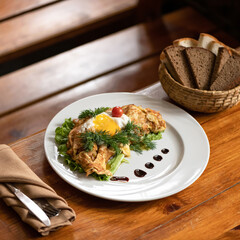Scrambled eggs omelet with lettuce, tomato and dill. Served breakfast or lunch on wooden table. Soft focus. Copy space.