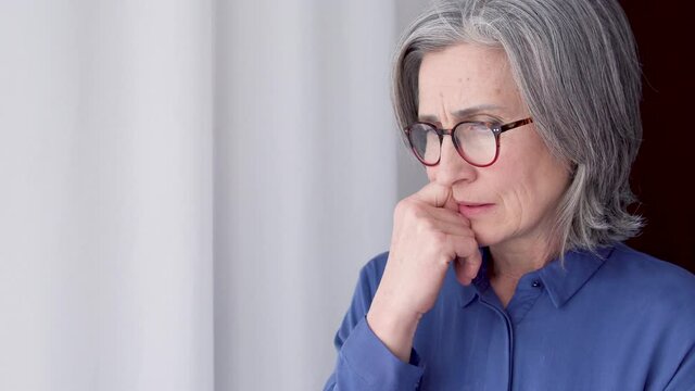 Anxious aged lady contemplating, harassing herself making difficult decision