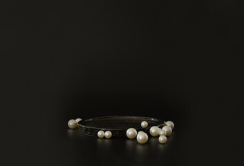 Black podium on the black background with pearls. Podium for product, cosmetic presentation....