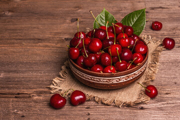 Fresh ripe sweet cherries in a bowl with droplets of water