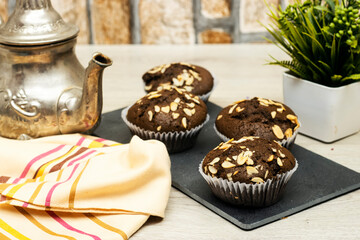 blackboard chocolate nuts muffins, Arabic teapot on wood table
