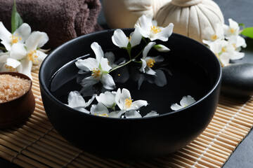 Obraz na płótnie Canvas Beautiful spa composition with jasmine essential oil and fresh flowers on table, closeup