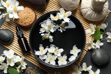 Fototapeta na wymiar Beautiful spa composition with jasmine essential oil and fresh flowers on table, flat lay