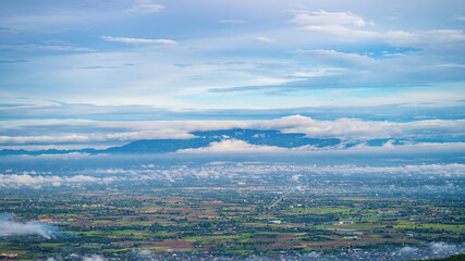 Fototapeta premium Unseen view point,White fog in the countryside and big mountains in Chiang Mai, Thailand, Blue clouds and vapor from the humid air after the rain, giving a soothing feeling.