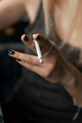 hands holding cigarettes