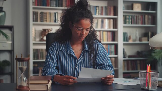 Upset stressed indian ethnic young woman feel frustrated open envelope at home reading bad news receive paper post mail letter about financial problem, bank debt bill, failed exam test results.