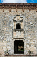 Fototapeta na wymiar dramatic image facade of a old stone entrance way and window from the 15th century, in downtown colonial district of Santo domingo, dominican republic.