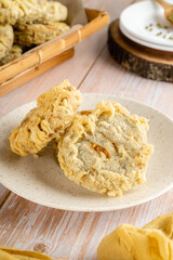 Gandasturi or kue kacang ijo. a cake from indonesia made from green beans and brown sugar, shaped round and flat, coated with flour and then fried.