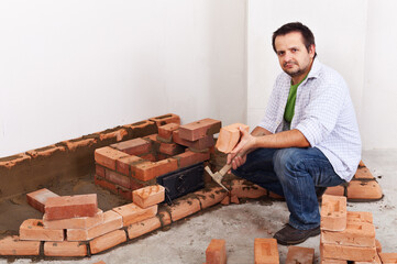 Worker starting building masonry heater