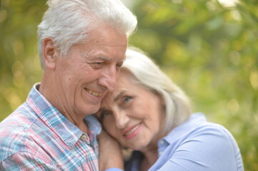 senior couple posing in the park