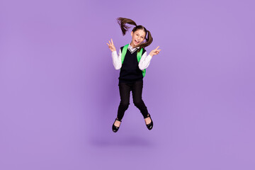 Fototapeta na wymiar Photo of friendly schoolgirl jump show v-sign wear rucksack glasses uniform isolated purple color background
