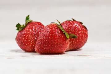 Fresh strawberries on a wooden rustic white background. Top view.