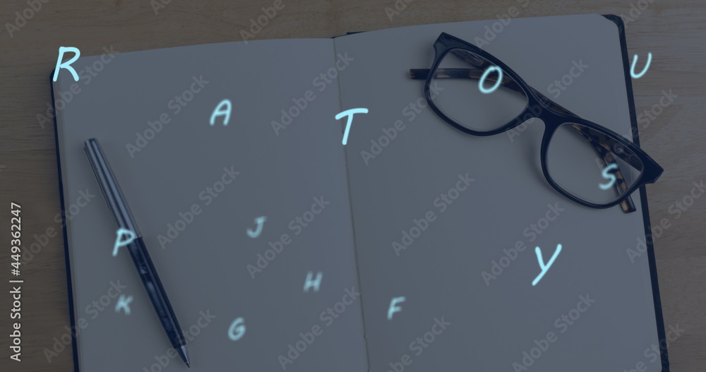 Poster multiple alphabets floating against glasses and pen on open notebook against wooden surface