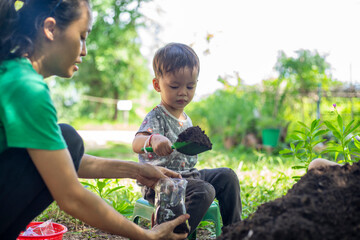 Children preparing soil for planting. Black soil is suitable for cultivation..