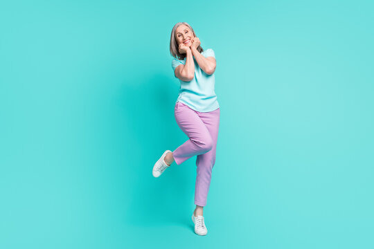 Full size photo of mature funky funny cheerful gorgeous woman adore admire enjoy weekend isolated on turquoise color background
