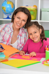 Mother teaches her cute daughter to do craft items