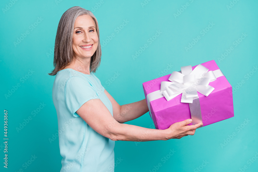 Sticker Profile side photo of good mood cheerful grandmother give copyspace present box isolated on teal color background