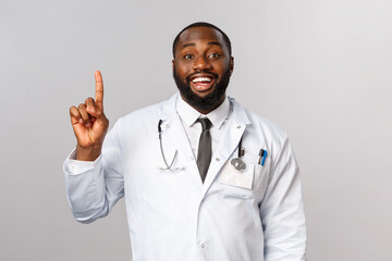 Portrait of cheerful african-american male doctor explain one simple task for patient stay healthy,...