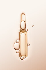 ampule with serum and bubbles around on cream-coloured background. - obrazy, fototapety, plakaty