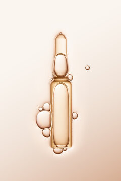 ampule with serum and bubbles around on cream-coloured background.