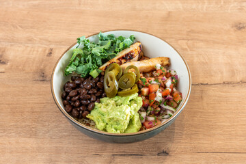 Great Mexican-style bowl with grilled chicken, pico de gallo, guacamole, black beans, green kale and jalapenos with a white rice base