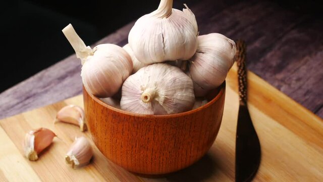 close up pf garlic in a container on table 