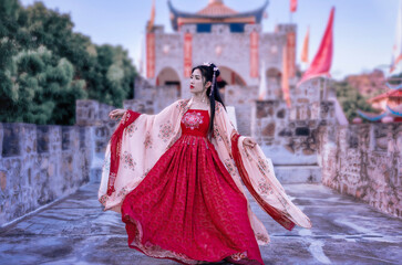 Asian woman wearing a red Chinese culture dress visit Santichon Village, Pai, Mae Hong Son province, Thailand.