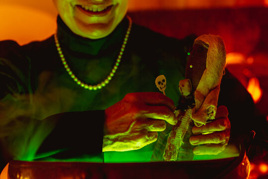 detail of hands of elderly person performing witchcraft. unrecognizable person celebrating halloween.