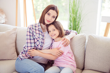 Photo of positive happy people siblings smile good mood hug sit sofa indoors inside house home apartment