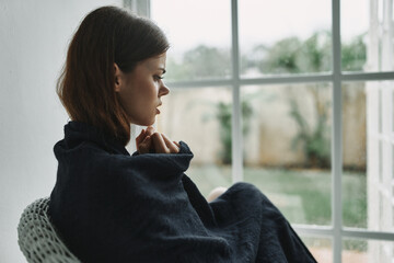 woman at home hiding with a blanket loneliness depression