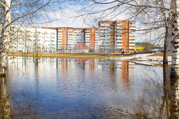 Fototapeta na wymiar Lake in the park. Flooding of the city in spring. Water and blue sky.