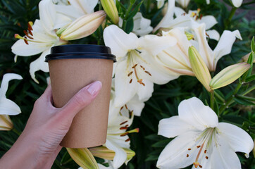 coffee to go on a background of lily flowers
