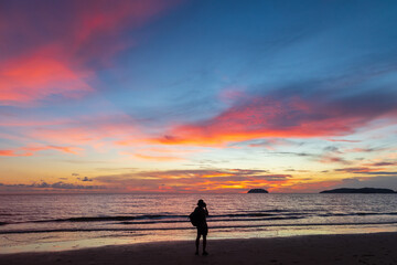 Fototapeta na wymiar Unidentified Photographer taking a beautiful twilight sunset at Tanjung aru beach, Sabah, Malaysia