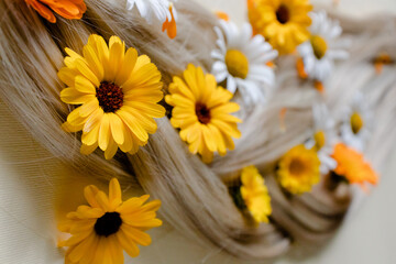 Medicinal flowers with soft blond hair. Summer flowers in hair.