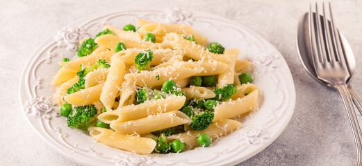 Pasta with green peas, broccoli and parmesan cheese.