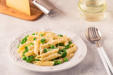 Pasta with green peas, broccoli and parmesan cheese.