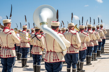 Military orchestra of Bulgaria. Stage, Shipka. Musicians from a military band photographed from behind against a blue sky. Military parade uniform. A police band is playing on Shipka Peak, Bulgaria.