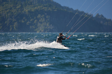 man kitesurfing in lake moreno near bariloche
