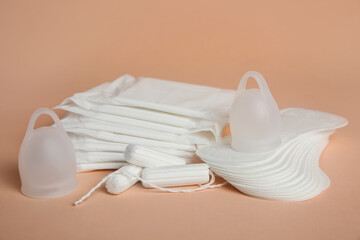 Fototapeta na wymiar Menstrual pads and other period products on pale orange background