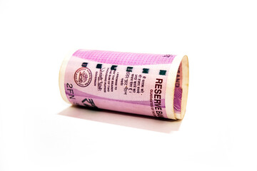 Indian two thousand rupees rolled up banknote isolated on white background.