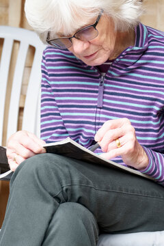 Senior Elderly Person Keeping Mind Active By Doing Crossword Puzzle