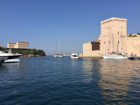 The entrance to the Old Port, flanked by the Pharo Palace on the left and Fort Saint-Jean on the right, seen from the Vieux Port marina in Marseille, France.