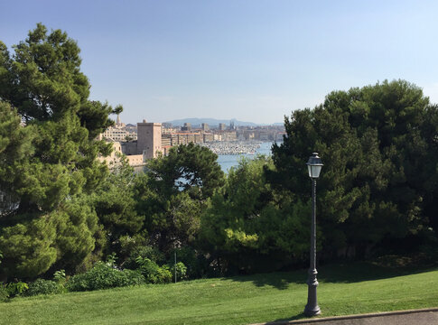 Panoramic view of the entrance to the Old Port flanked by the Fort Saint-Jean on the left, seen from the Pharo Palace in Marseille, France.