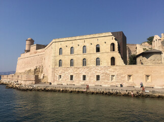 Fototapeta premium The Fort Saint Jean with the large round Tour du Fanal tower, one of the most visited monuments in Marseille. It is connected to the former port by a footbridge.